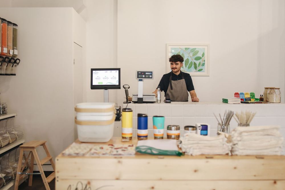 Shop owner behind the counter of a small store