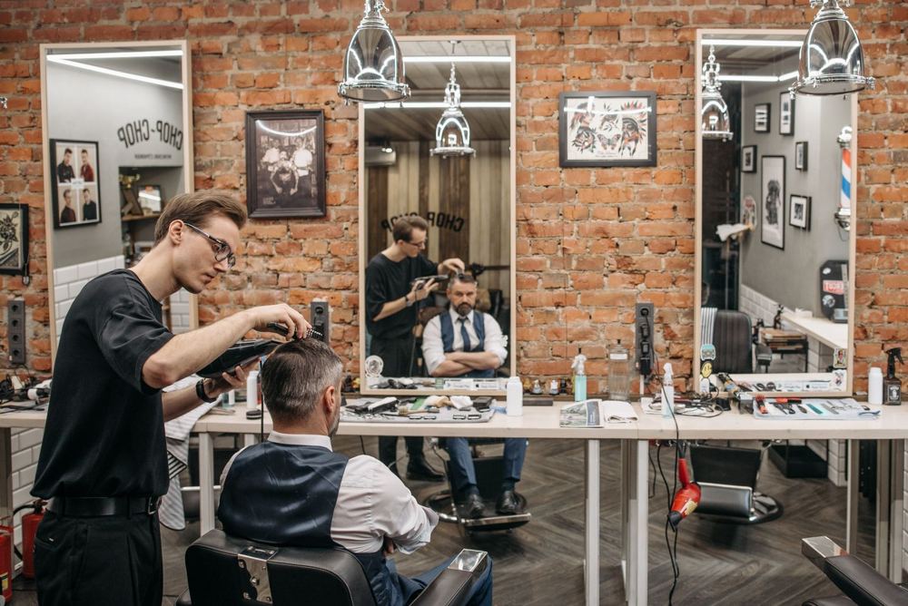 Barber cutting a client's hair in a barbershop